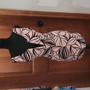 Cream and black plunging V neck line and criss-cross low  back w/ flower pattern